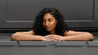 Woman leaning on edge of chiller