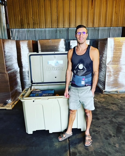 A photo of a man  posing with his new cold plunge tub from Desert Plunge.