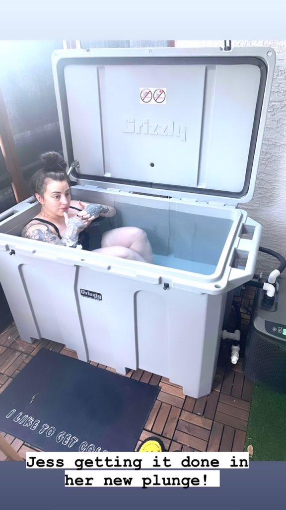 A photo of a woman enjoying her gray cold plunge tub from Desert Plunge.