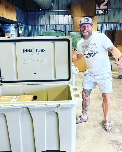 A photo of man posing with his brand new cold plunge tub from Desert Plunge.