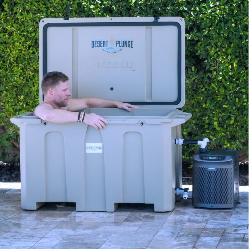 A photo of a man enjoying a soak in a quarter horsepower cold plunge tub from Desert Plunge.