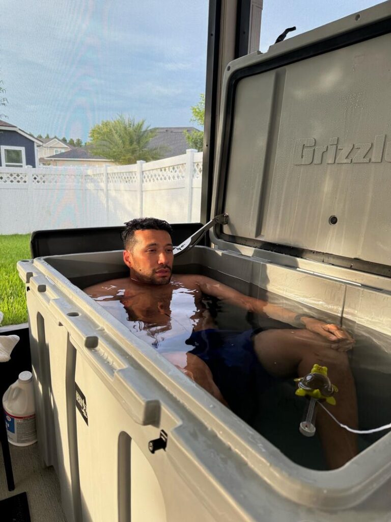 A photo of a man enjoying a cold plunge in his Desert Plunge ice bath.