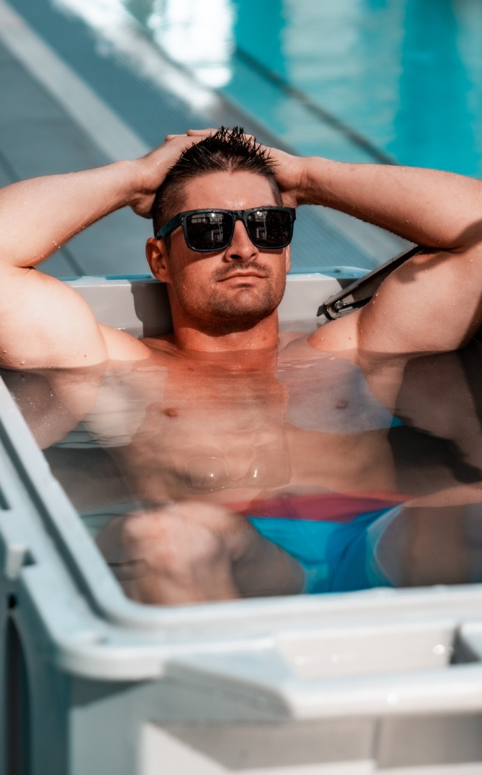 A photo of a man outdoors relaxing in a 3/4 horsepower cold plunge tub from Desert Plunge. 