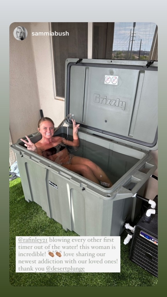 A woman showing peace signs as she does cold therapy outside in her Desert Plunge cold plunge tub.