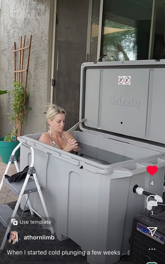 A woman praying or meditating in her cold plunge tub from Desert Plunge.