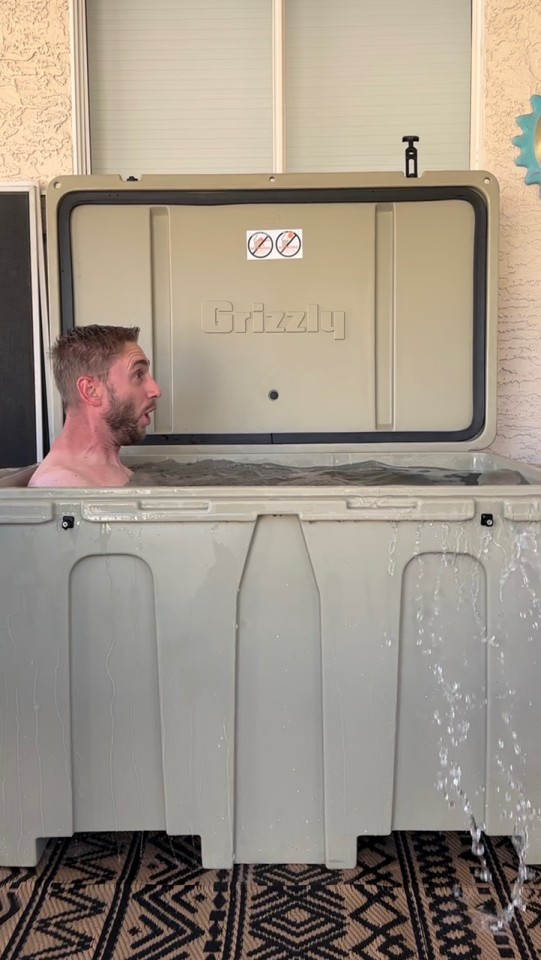 A man enjoying cold therapy in his tan cold plunge tub from Desert Plunge.