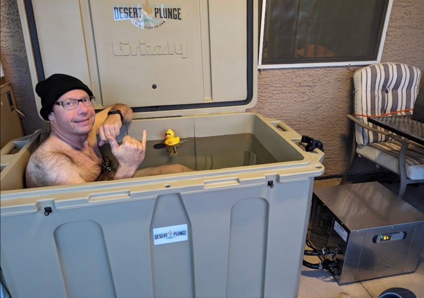 A photo of a happy Desert Plunge customer using his cold plunge tub.